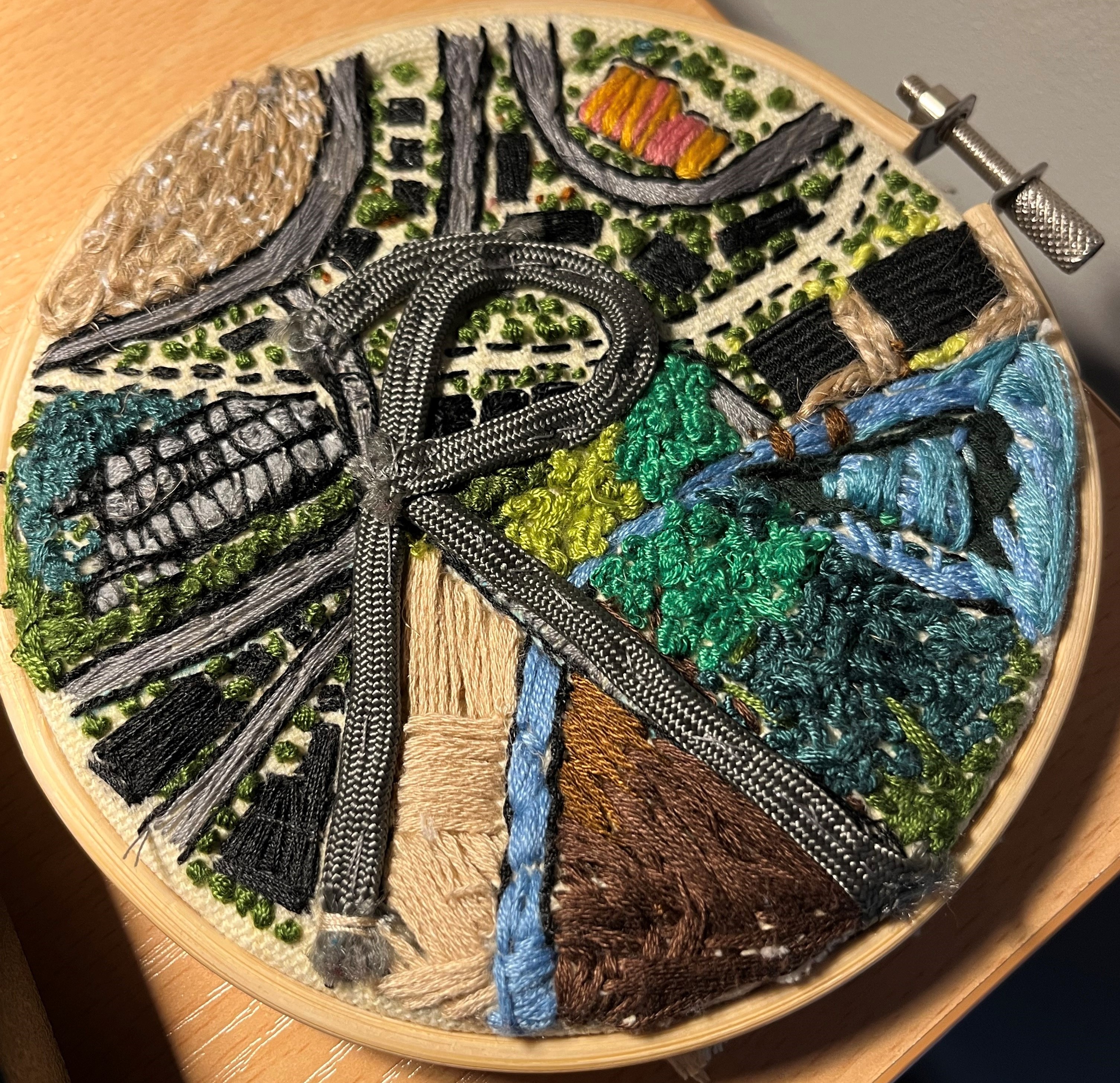 Textile art piece showing a map with the letter R - for decorative purposes only